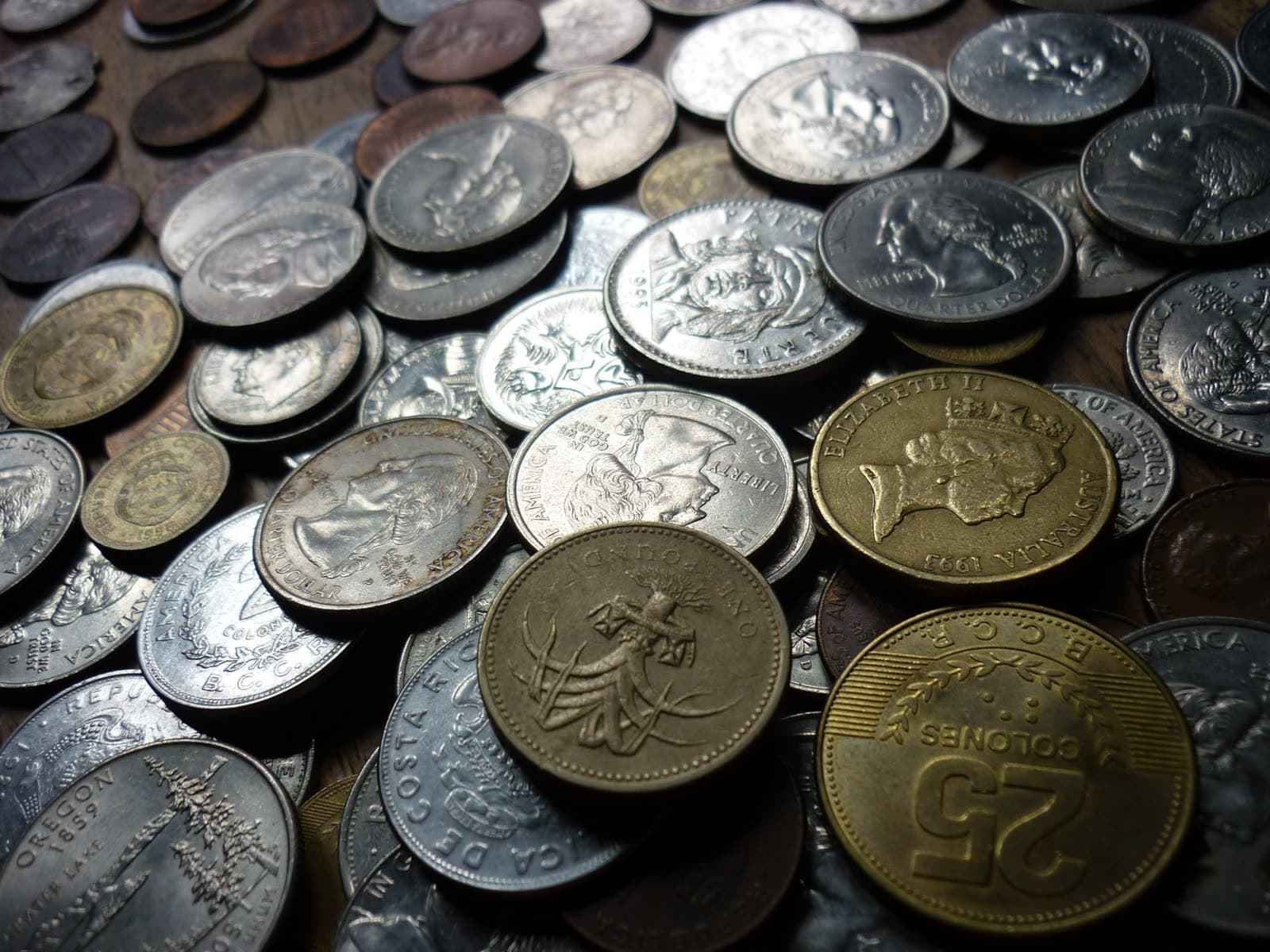 A close-up pile of mixed silver and gold coins